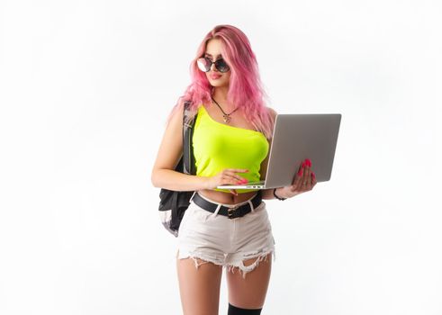 sexy girl in bright summer clothes with a laptop on a white background copy paste