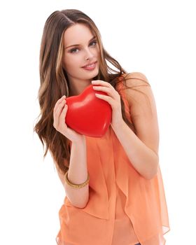 Portrait, heart and love with a woman in studio on a white background holding an emoji, icon or shape. Red, romantic and valentines day with a young female holding a symbol or romance in her hands.