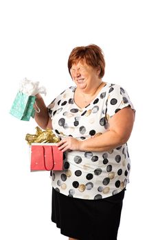 Isolated portrait of a fifty year old overweight red hair woman, holding two gift bag and laughing at the choice