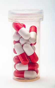 Close up of an isolated bottle of red and white pill