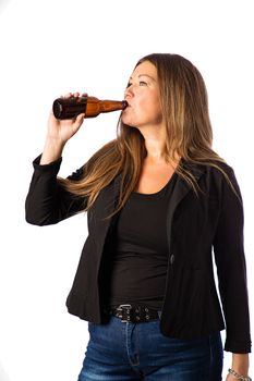 Isolated portrait of a forty year old woman in a sport coat taking a sip from a brown beer bottle