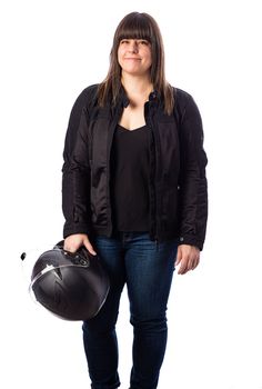 Isolated portrait of a forty year old woman, wearing a biker coat, holding a black motorcycle helmet