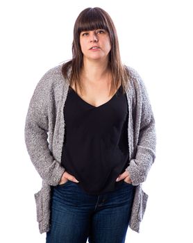 Isolated portrait of a fifty year old woman, with brown hair and bangs, looking tired