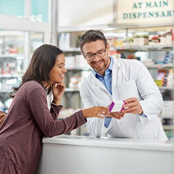 Happy, medicine and pharmacy worker with customer for help, recommendation and expertise at counter. Pharmaceutical advice and opinion of pharmacist helping girl with medication information at store