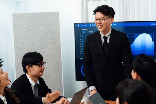 Business team of financial data analysis meeting with business intelligence, report paper and dashboard on laptop for marketing strategy. Business people working together to promote harmony in office.
