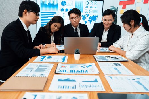 Business team of financial data analysis meeting with business intelligence, report paper and dashboard on laptop for marketing strategy. Business people working together to promote harmony in office.