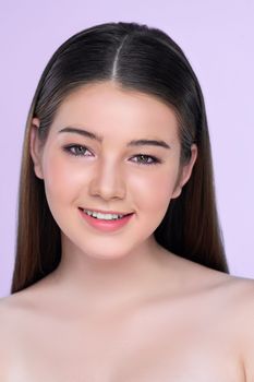 Natural beauty closeup portrait of young charming brunette girl looking at camera. Perfect smooth face skin attractive young girl with bare shoulder for skincare and cosmetic product.