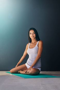 Ready to get my yoga on. A young woman stretching on a yoga mat