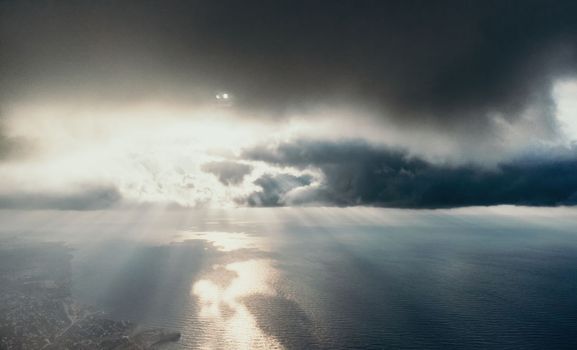 Blue sky with white clouds over calm summer panorama of the sea. Drone aerial view. Abstract aerial nature summer ocean sunset sea and sky background. Horizon. No people. Holiday and vacation concept