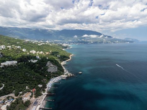 Christian church on a background of mountains. Temple of the Holy Archangel Michael in Oreanda. The southern coast of Crimea. Located on a rocky cliff and is surrounded by beautiful vegetation