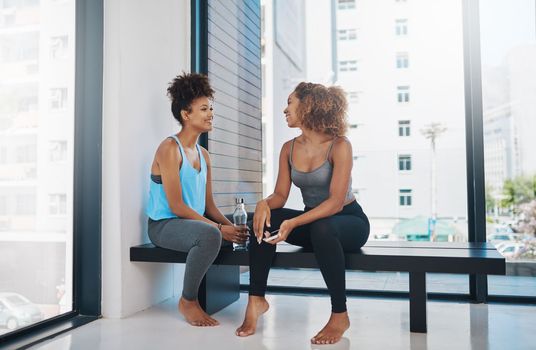 Im really enjoying these yoga classes. Full length shot of two young women talking after yoga class