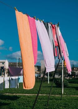 Colorful clothes hanging on line in garden.