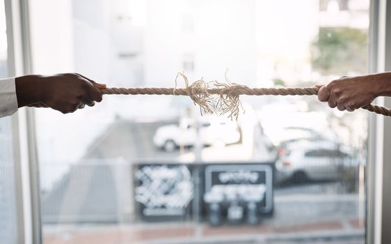 Trying to succeed in a competitive market. unrecognizable businesspeople pulling on a rope during tug of war