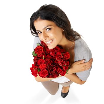 Above, portrait and woman with rose in studio for love, romance and valentines day on white background space. Happy, smile and bouquet for indian girl face hug floral, gesture and romantic isolated.