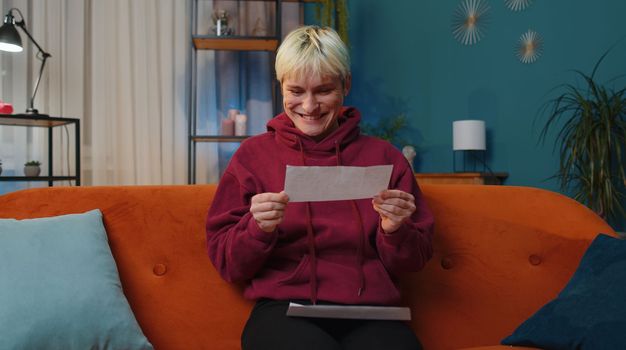 Happy woman open envelope letter, reading it. Career growth advance promotion, bank loan approve, successful admission to university monetary award long-awaited invitation great news, lottery game win