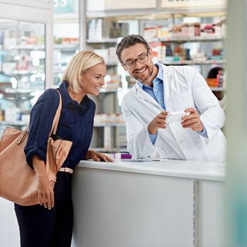 Pharmacist with pills, help customer and health with medicine and service in pharmacy with advice and prescription. Healthcare, medical shop with pharmaceutical drugs with man and woman talking.