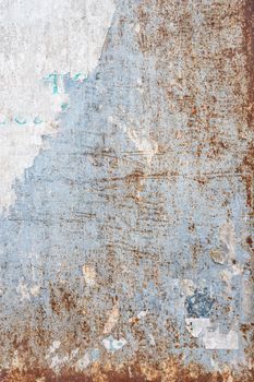 Grunge ripped poster background - texture of torn advertisement on an old rusty billboard panel.