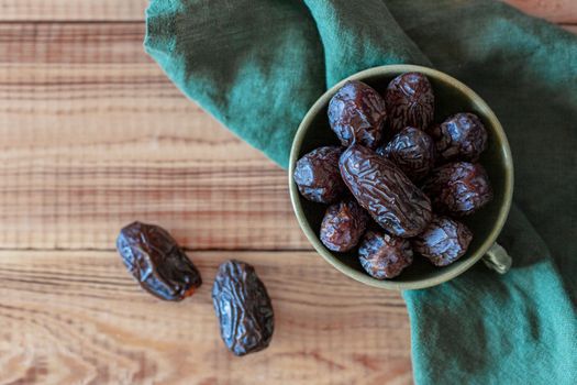 dates fruits in a bowl, top view, copy space
