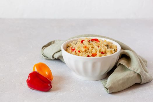 portion of gluten free quinoa cooked with bell peppers, side view