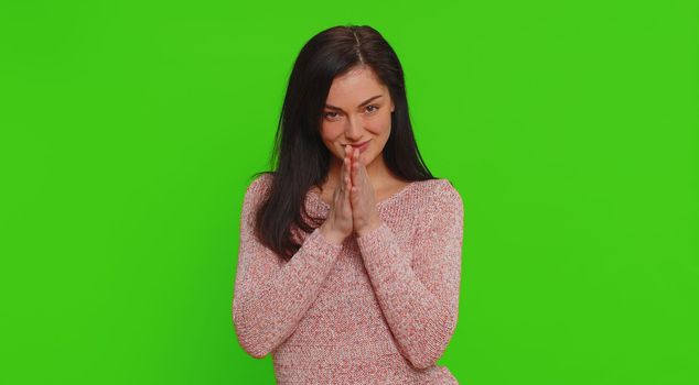 Sneaky cunning woman with tricky face gesticulating and scheming evil plan, thinking over devious villain idea, cheats, revenge, jokes pranks. Young girl isolated on green screen chroma key background