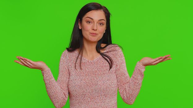 I dont know what to say. Confused woman feeling embarrassed about ambiguous question, having doubts, no idea, being clueless and uncertain. Young pretty girl isolated on green chroma key background