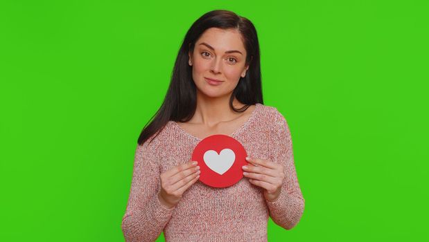 Like. Hipster one pretty woman show heart banner inscription agrees with something, gives positive reply recommends advertisement likes good. Young girl isolated alone on green chroma key background