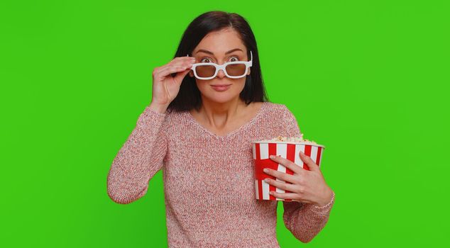 Excited woman in 3D glasses eating popcorn and watching interesting TV home serial, sport game, film, online social media movie content. Girl enjoying domestic entertainment on chroma key background
