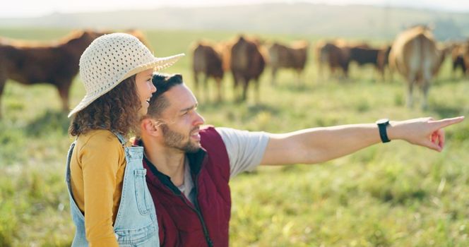 Father and daughter bonding on a cattle farm, talking and having fun while looking at animals in nature. Love, family and girl learning about livestock with caring parent, enjoying conversation.