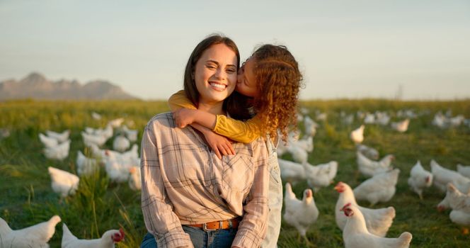 Hug, child and mother on a farm with chicken on mothers day, travel or holiday in Argentina together. Happy, portrait and kiss from girl with her mama on a field with animals during vacation.