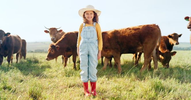 Happy, girl and farm, cow and sustainability in agriculture with a smile for growth, freedom and portrait. Countryside child, smile or kid in a field of grass, cattle and ecology livestock animals.