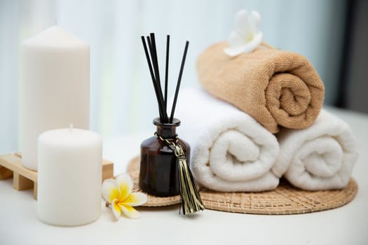 Spa accessory composition set in day spa hotel , beauty wellness center . Spa product are placed in luxury spa resort room , ready for massage therapy from professional service .