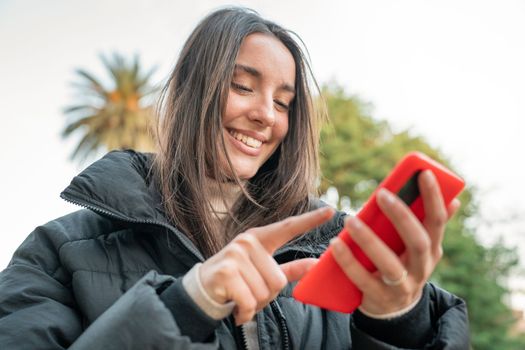 Influencer woman making a selfie blog outdoors in the park. Happy smiling lady student taking video call. Technology, education, Erasmus and communication concept. High quality photo