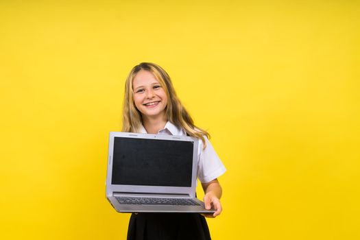 Little happy blonde kid girl 12-13 years laptop computer. Children lifestyle childhood concept.