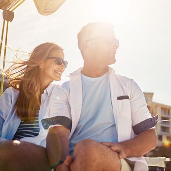 Happy couple, bonding or sailing yacht on ocean sea for relax holiday, vacation or Greece summer break. Smile, happy man or mature woman on boat for retirement, travel location sightseeing or freedom.