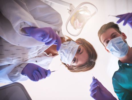 May the floss be with you. two dentists getting ready to work on a patient