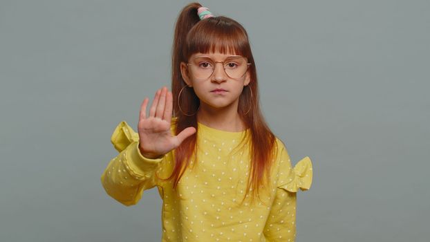 Stop gesture. Angry young preteen child girl kid say No hold palm folded crossed hands, warning of finish, prohibited access, declining communication, body language, danger. Little toddler children