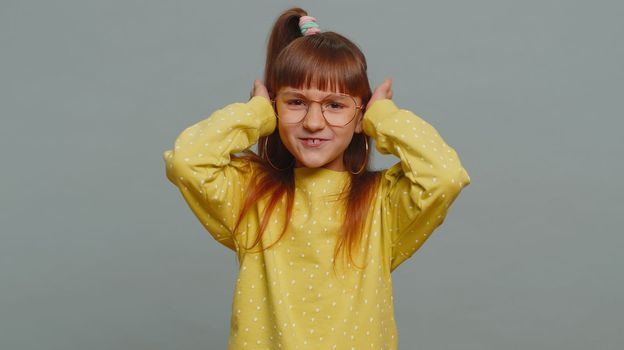 Dont want to hear, listen. Frustrated annoyed irritated young toddler school girl in glasses covering ears, gesturing No, avoiding advice ignoring unpleasant noise loud voices. Teen female child kid