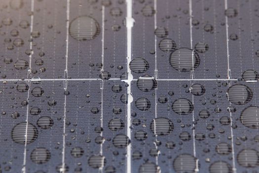 Green energy. Solar panels with raindrops close up. The use of waterproof solar panels in difficult environments, the production of green energy