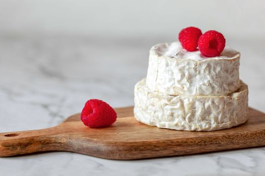 camembert french soft cheese served with raspberries, minimalism