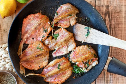 red mullet fish cooked on a pan, side view, top view