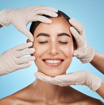 Plastic surgery, beauty and woman in a studio for a skincare, natural and cosmetic facial treatment. Cosmetics, self love and surgeon hands on a female model face for consultation by blue background