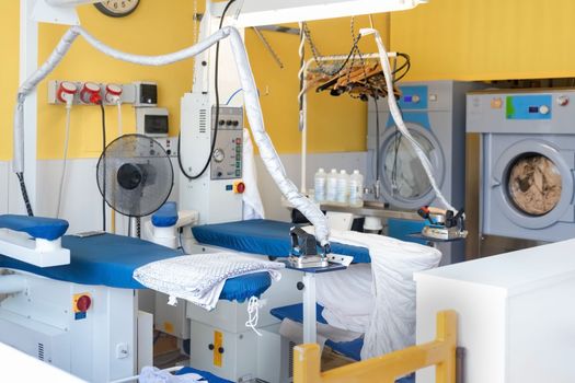 Laundry equipment. Professional Ironing table. Dry cleaning servicing.
