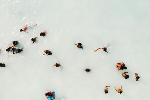 The view from the bird's eye view of the ocean, filled with people on a hot Sunny day.People swim in the Indian ocean on the island of Mauritius.