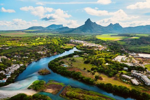 A river flowing into the ocean on the tropical island of Mauritius.Nature on the island of Mauritius, mountains and river of the island of Mauritius.