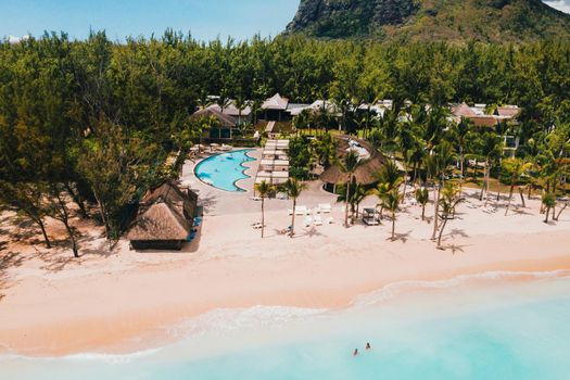 A bird's-eye view of the beach near the resort and the ocean next to mount Le Morne Brabant.Coral reef of the island of Mauritius.