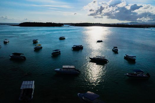 Aerial picture of the east coast of Mauritius Island. Beautiful lagoon of Mauritius Island shot from above. Boat sailing in turquoise lagoon.