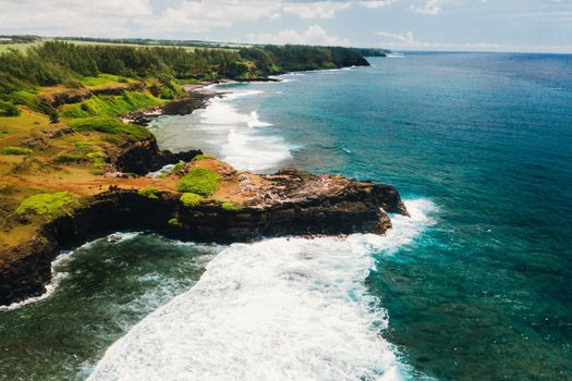 View of the famous Golden beach between black volcanic rocks on the banks of the Gris-Gris river,La Roche qui pleure in Mauritius.