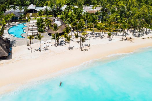 A bird's-eye view of the beach near the resort and the ocean next to mount Le Morne Brabant.Coral reef of the island of Mauritius.