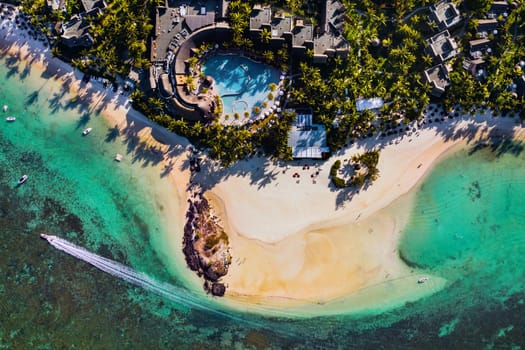 Aerial picture of the east coast of Mauritius Island. Flying above the turquoise lagoon of Mauritius in the region of Belle Mare