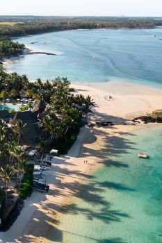 View from the height of the east coast of the island of Mauritius. Flying over the turquoise lagoon of the island of Mauritius in the area of Bel Mare